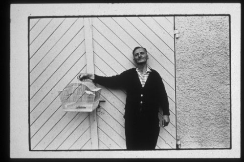 Peter's photo of man holding a bird cage